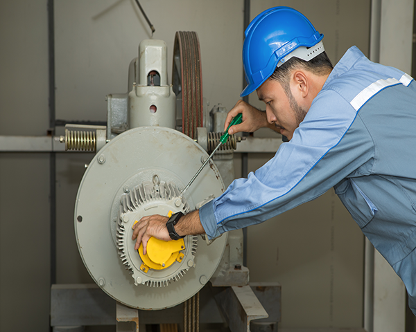 Picture of a maintenance worker working on a piece of electrical equipment.