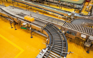 Image of a sorting conveyor system in a warehouse.